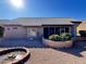 Backyard view, showing patio, gravel, and low desert landscaping at 13706 W Caballero Dr, Sun City West, AZ 85375