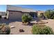 Landscaped backyard with patio, small trees, and rock garden at 13706 W Caballero Dr, Sun City West, AZ 85375