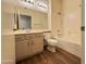 Clean bathroom, featuring a tub and light wood vanity at 13706 W Caballero Dr, Sun City West, AZ 85375