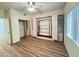 Bright bedroom with mirrored closet and wood-look floors at 13706 W Caballero Dr, Sun City West, AZ 85375