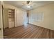 Bedroom with built-in murphy bed and wood flooring at 13706 W Caballero Dr, Sun City West, AZ 85375