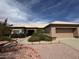 Inviting single-story home featuring a tile roof, desert landscaping, and an attached two-car garage at 13706 W Caballero Dr, Sun City West, AZ 85375