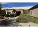 Tan house with tile roof, landscaped yard, and two-car garage at 13706 W Caballero Dr, Sun City West, AZ 85375