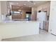 Open kitchen with island and stainless steel appliances at 13706 W Caballero Dr, Sun City West, AZ 85375