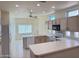U-shaped kitchen with light wood cabinets, white countertops, and ample counter space at 13706 W Caballero Dr, Sun City West, AZ 85375