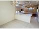 Open kitchen with breakfast bar and view to Gathering room at 13706 W Caballero Dr, Sun City West, AZ 85375