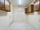 Laundry room with upper cabinets and tiled flooring at 13706 W Caballero Dr, Sun City West, AZ 85375