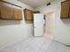 Laundry room with built-in cabinets and access to exterior at 13706 W Caballero Dr, Sun City West, AZ 85375
