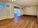 Bright living room with hardwood floors, high ceilings, and sliding glass doors at 13706 W Caballero Dr, Sun City West, AZ 85375