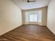 Spacious living room with bay window and wood-look floors at 13706 W Caballero Dr, Sun City West, AZ 85375