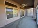 Bright, airy screened patio with ceiling fan and carpet flooring at 13706 W Caballero Dr, Sun City West, AZ 85375