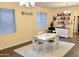 Sunlit dining room showcasing a white table with seating for four, a white rug, and a beverage bar at 1023 W Ingram St, Mesa, AZ 85201
