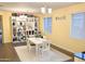 Bright dining room features white table with seating for four, open shelving, and light neutral walls at 1023 W Ingram St, Mesa, AZ 85201