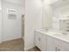 Bright bathroom with double sink vanity, light wood look tile floor, and open shelving at 15995 W Cottontail Ln, Surprise, AZ 85387