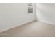 An empty bedroom with neutral carpet and natural light from the window at 15995 W Cottontail Ln, Surprise, AZ 85387