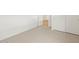 Bedroom with neutral carpet, base trim and a view into the hallway at 15995 W Cottontail Ln, Surprise, AZ 85387