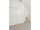 Bedroom with neutral carpet and closet with large sliding doors, offering ample storage solutions at 15995 W Cottontail Ln, Surprise, AZ 85387