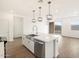 Open kitchen with center island with stainless steel dishwasher, with pendant lights overhead at 15995 W Cottontail Ln, Surprise, AZ 85387