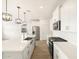 Open concept kitchen with stainless steel appliances, white cabinetry, and a large island with a sink at 15995 W Cottontail Ln, Surprise, AZ 85387
