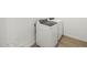 Laundry room featuring modern, front-load washer and dryer on a light wood tile floor at 15995 W Cottontail Ln, Surprise, AZ 85387
