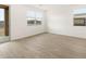 Bright living room with wood-style floors and sliding glass doors at 15995 W Cottontail Ln, Surprise, AZ 85387