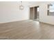 Bright living room features wood-style floors and sliding glass doors at 15995 W Cottontail Ln, Surprise, AZ 85387