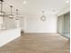 Bright living space with wood-style floors and modern pendant lights at 15995 W Cottontail Ln, Surprise, AZ 85387
