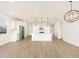Open floor plan with wood-style floors connects kitchen and living areas at 15995 W Cottontail Ln, Surprise, AZ 85387