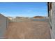 Unlandscaped backyard with cinder block fencing and a view of nearby houses at 28250 N 134Th Ave, Peoria, AZ 85383