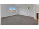 Carpeted bedroom with large window offering natural light and neighborhood views at 28250 N 134Th Ave, Peoria, AZ 85383