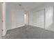 Bright bedroom with neutral carpet and a view of the closet and doorway at 28250 N 134Th Ave, Peoria, AZ 85383