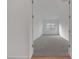 A carpeted bedroom with a window is visible from the wooden floor of the hallway at 28250 N 134Th Ave, Peoria, AZ 85383