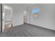 Bedroom with a view into the closet, neutral carpet and white walls at 28250 N 134Th Ave, Peoria, AZ 85383