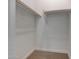 Walk-in closet with neutral carpet, white walls, and wooden rails at 28250 N 134Th Ave, Peoria, AZ 85383