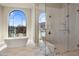 Luxury bathroom with soaking tub, glass shower, and marble floors at 10739 E Diamond Rim Dr, Scottsdale, AZ 85255