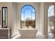 Bathroom featuring a freestanding tub and large window with scenic view at 10739 E Diamond Rim Dr, Scottsdale, AZ 85255