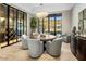 Elegant dining room with a round table, wine cellar, and stunning mountain views at 10739 E Diamond Rim Dr, Scottsdale, AZ 85255