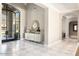 Elegant entryway with marble floors, modern console table, and arched doorways at 10739 E Diamond Rim Dr, Scottsdale, AZ 85255