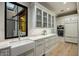 Butler's pantry with farmhouse sink and ample storage at 10739 E Diamond Rim Dr, Scottsdale, AZ 85255