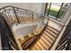 Elegant curved staircase with wrought iron railing and crystal chandelier at 10739 E Diamond Rim Dr, Scottsdale, AZ 85255