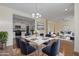Open concept dining room with white table and blue chairs, overlooks living room and kitchen at 1670 E Joseph Way, Gilbert, AZ 85295