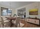 Bright dining room with wooden table and chairs, open to kitchen at 1670 E Joseph Way, Gilbert, AZ 85295
