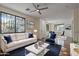 Spacious living room with hardwood floors, comfortable seating, and large windows at 1670 E Joseph Way, Gilbert, AZ 85295