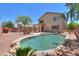 Inviting backyard features a private pool, desert plants, and a privacy fence for outdoor enjoyment at 43594 W Bravo Ct, Maricopa, AZ 85138