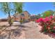 The backyard has desert landscaping, a rock garden, and a view of the home's exterior at 43594 W Bravo Ct, Maricopa, AZ 85138