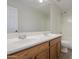 This bright bathroom features a double sink vanity, a large mirror, and a shower and tub combination at 43594 W Bravo Ct, Maricopa, AZ 85138