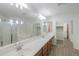 This bright and spacious bathroom features double sinks, a large mirror, and a separate tub and shower at 43594 W Bravo Ct, Maricopa, AZ 85138