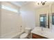 Bathroom features a shower and tub combination and single sink vanity with a large window above at 43594 W Bravo Ct, Maricopa, AZ 85138