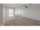 This expansive bedroom with plentiful windows and neutral carpet, is perfect for relaxation and rest at 43594 W Bravo Ct, Maricopa, AZ 85138