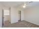 This comfortable bedroom features neutral carpet, paint, a ceiling fan, and a closet with sliding doors at 43594 W Bravo Ct, Maricopa, AZ 85138